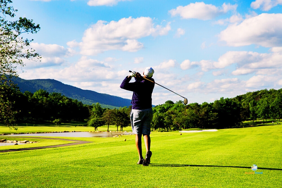 Golfer swinging on Vietnam Golf Tours course – Auasia Travel